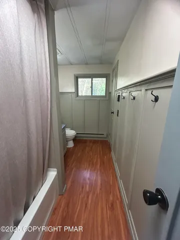 a view of a room with wooden floor and staircase