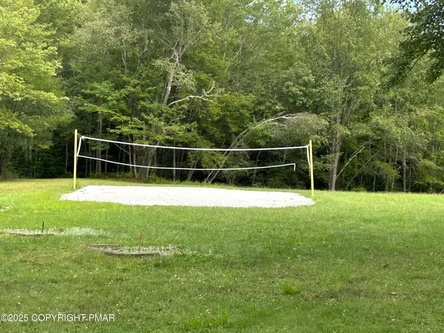 a view of a yard with a wooden fence
