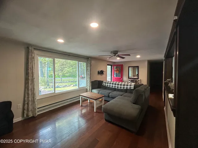 a living room with furniture and a large window
