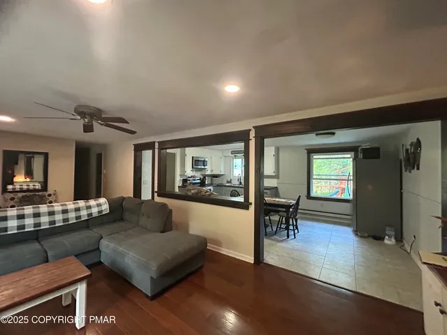 a living room with furniture and a wooden floor