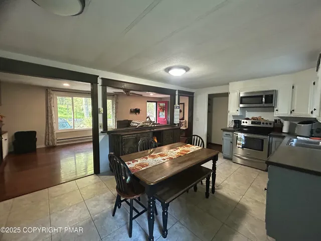 a kitchen with a table chairs and a refrigerator