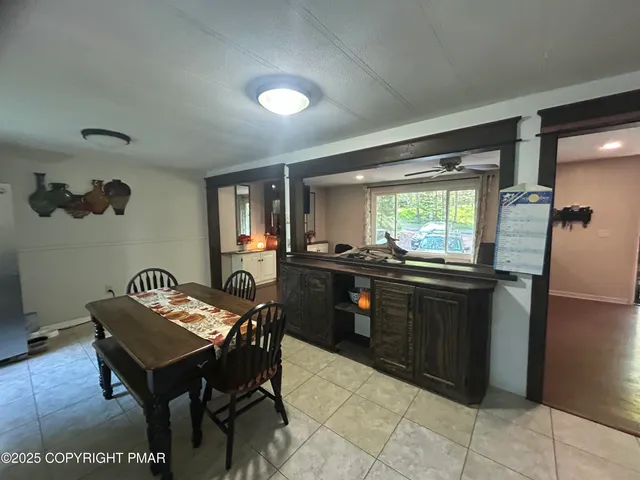 a dining room with furniture and window