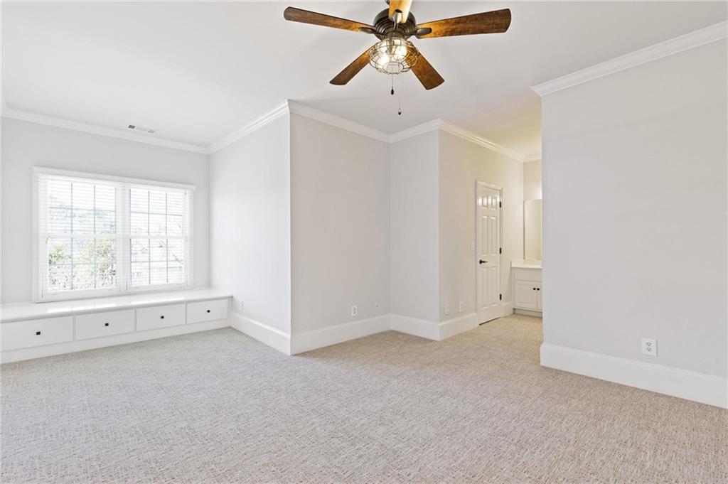 2010 Legends Way Braselton, GA 30517 - Photo 45 of 77 an empty room with chandelier fan and windows