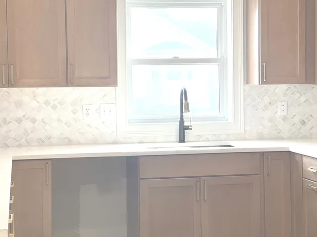 a view of a kitchen with a sink and dishwasher cabinet with wooden floor