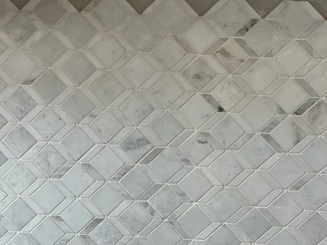 a kitchen with white cabinets and sink