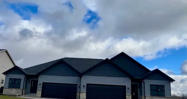 a view of a hallway with wooden floor and closet area