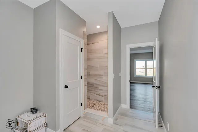 a view of a livingroom with a ceiling fan and wooden floor