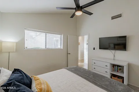 a bedroom with a bed and a flat screen tv