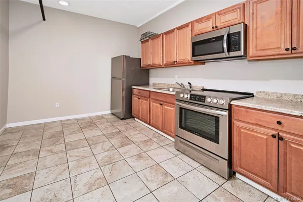 a kitchen with stainless steel appliances granite countertop a stove top oven microwave and cabinets