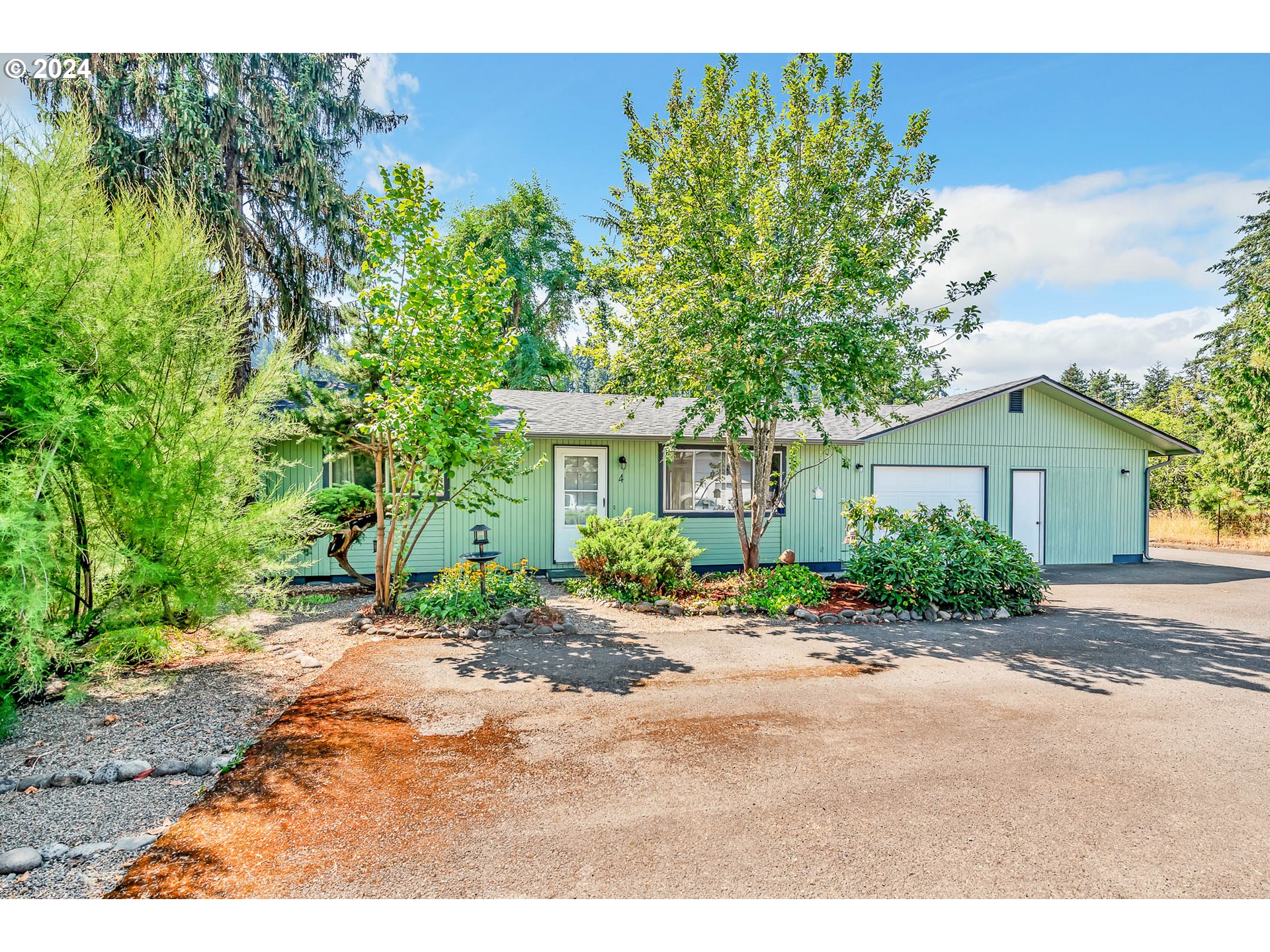 6112 Main Street Springfield, OR 97478 - Photo 1 of 47 a front view of a house with a yard and a garage