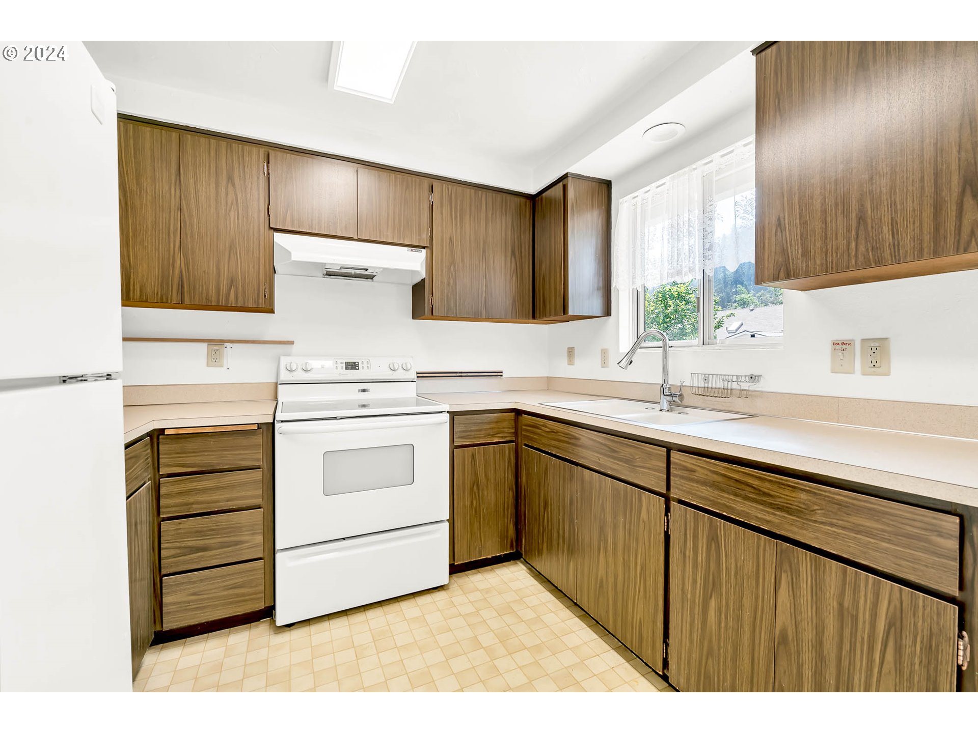 6112 Main Street Springfield, OR 97478 - Photo 11 of 47 a kitchen with a stove sink and cabinets