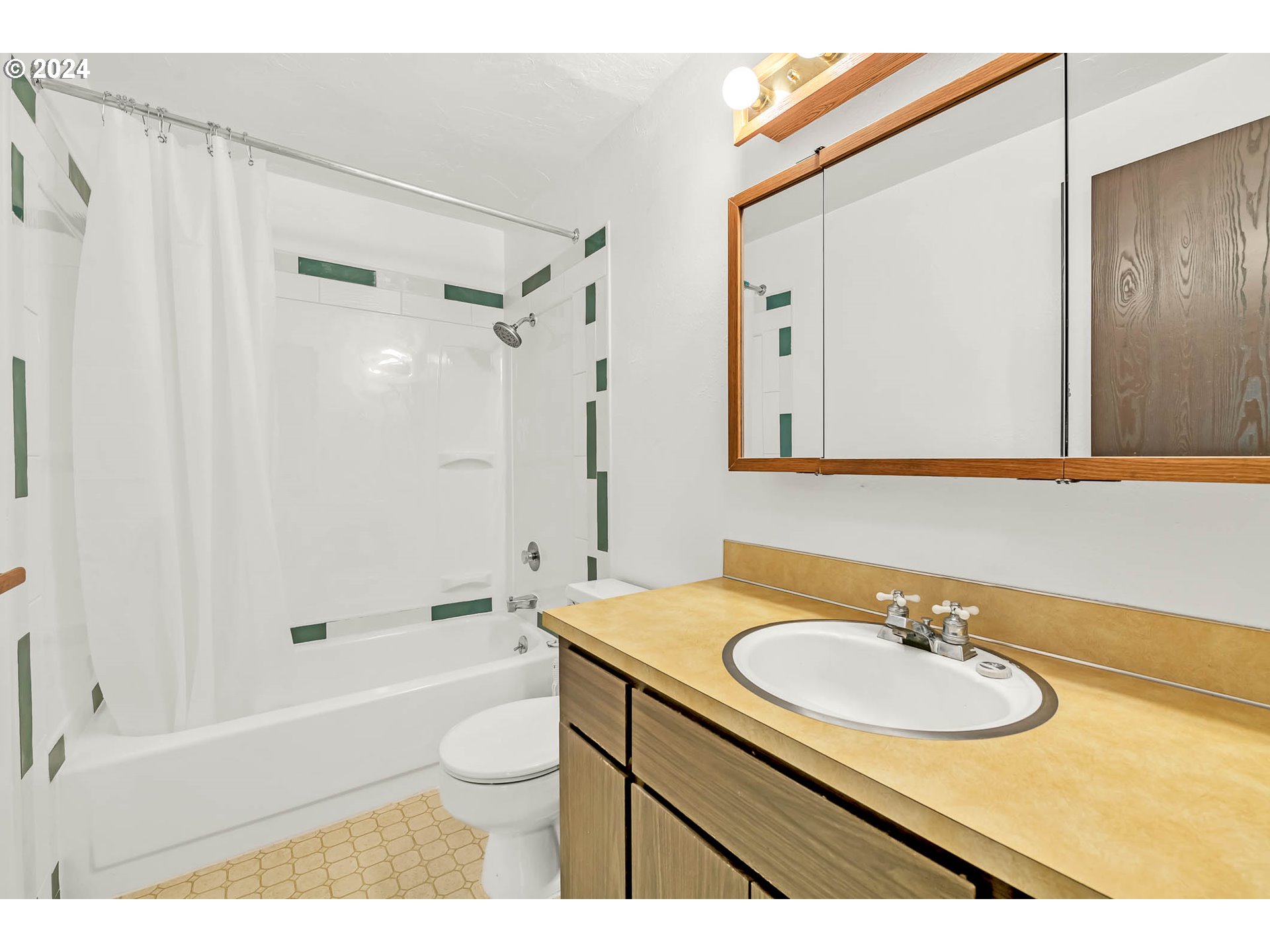6112 Main Street Springfield, OR 97478 - Photo 13 of 47 a bathroom with a granite countertop sink a mirror a bathtub and shower
