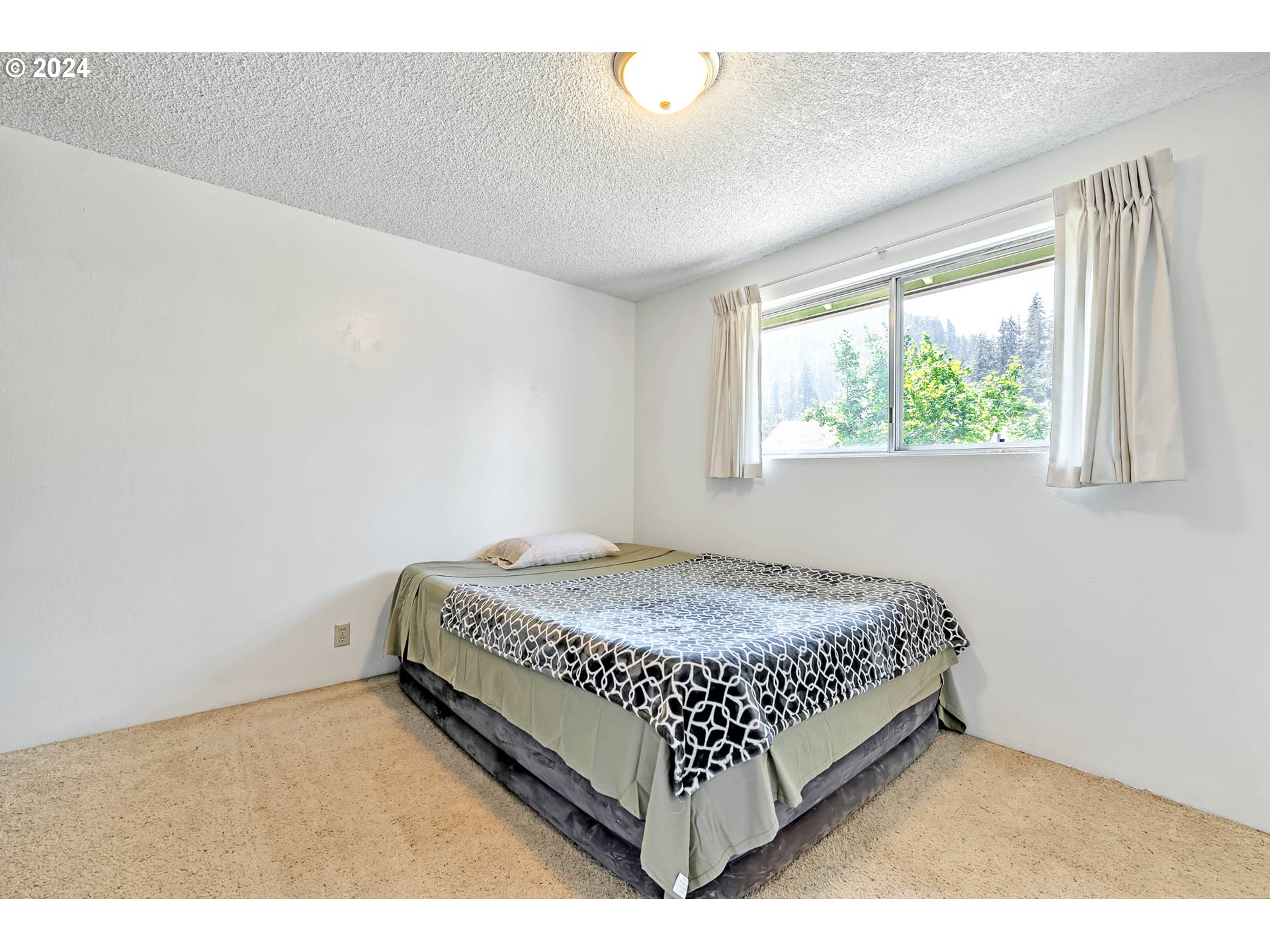 6112 Main Street Springfield, OR 97478 - Photo 14 of 47 a bed sitting in a bedroom next to a window