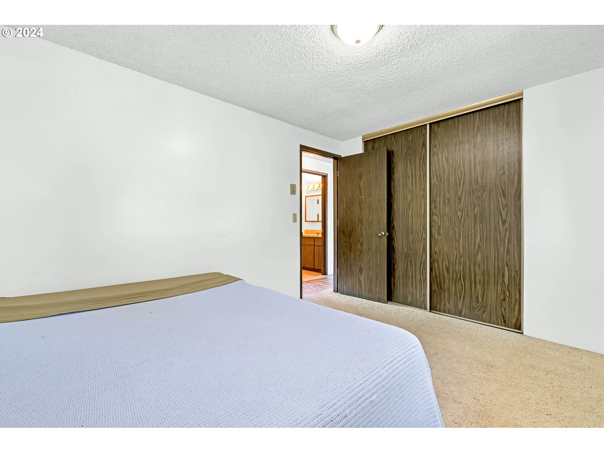 6112 Main Street Springfield, OR 97478 - Photo 17 of 47 a bedroom with a bed and a chandelier