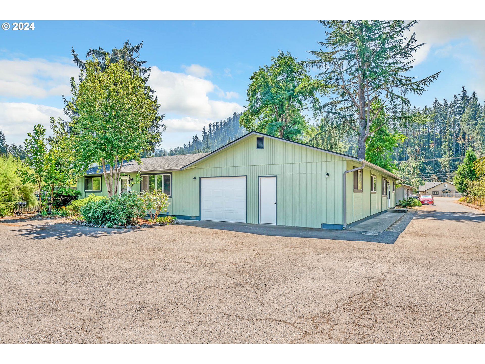 6112 Main Street Springfield, OR 97478 - Photo 2 of 47 a front view of a house with a yard and garage