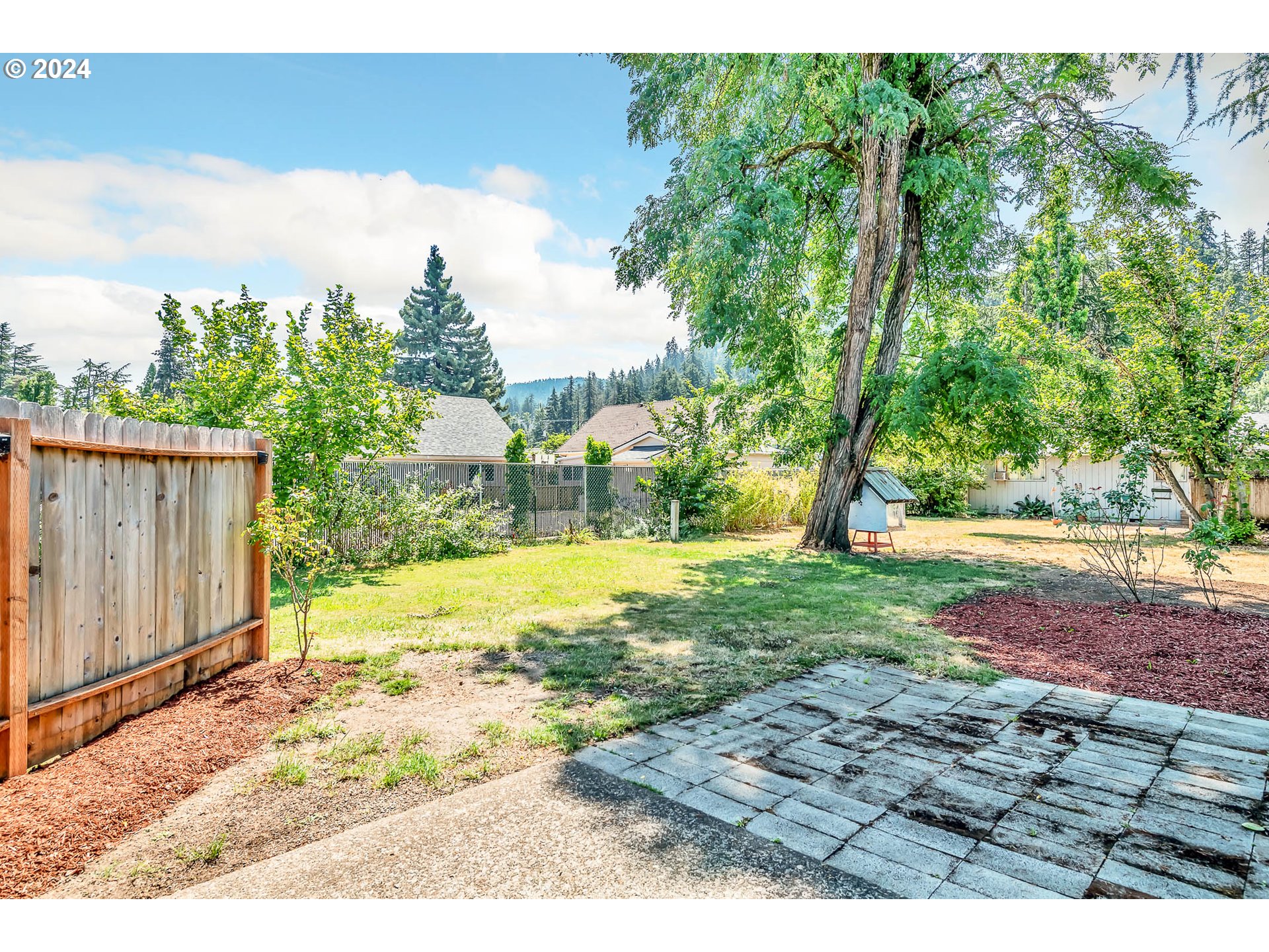 6112 Main Street Springfield, OR 97478 - Photo 25 of 47 a view of a backyard with large trees