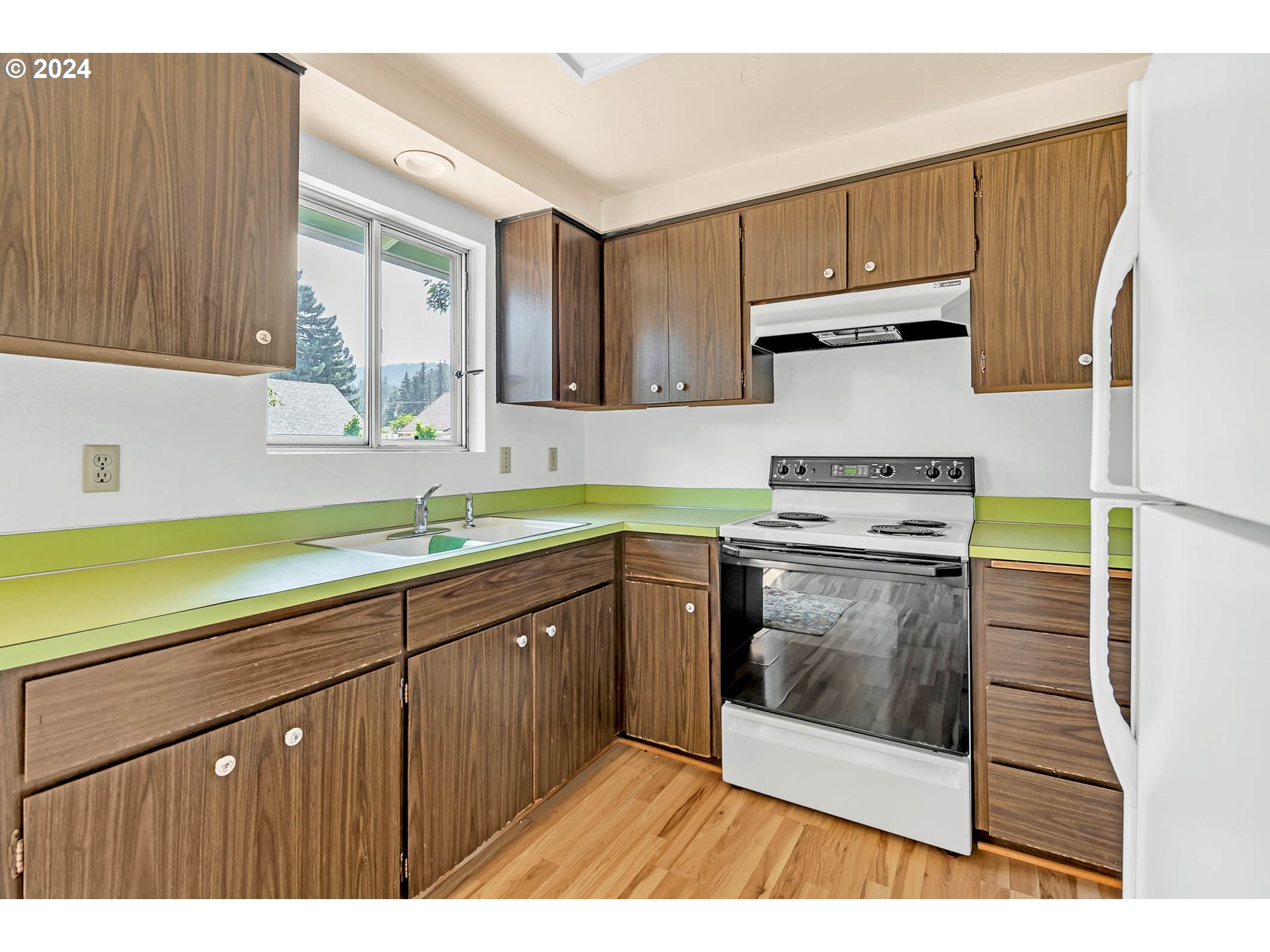 6112 Main Street Springfield, OR 97478 - Photo 31 of 47 a kitchen with a cabinets a sink and a stove