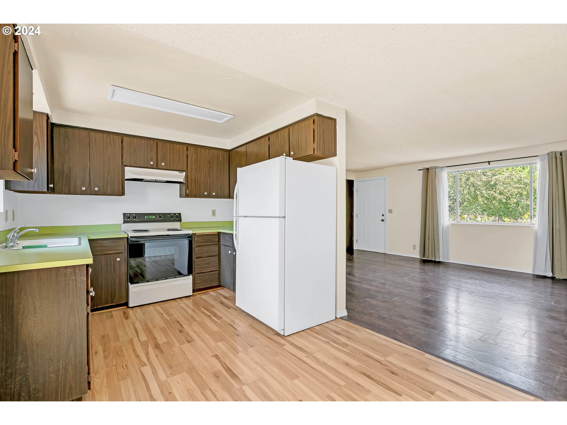 6112 Main Street Springfield, OR 97478 - Photo 33 of 47 a kitchen with granite countertop a refrigerator stove top oven and sink