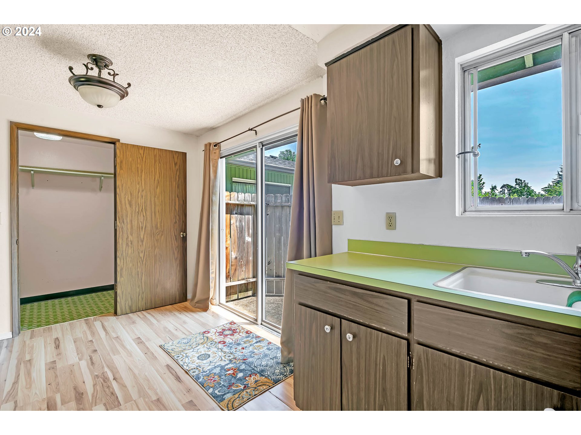 6112 Main Street Springfield, OR 97478 - Photo 34 of 47 a kitchen with a sink and wooden cabinets