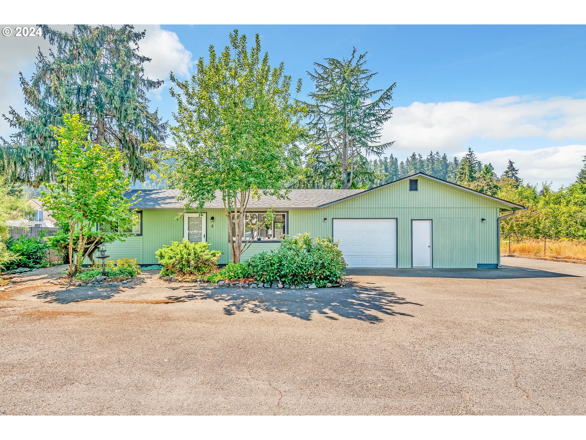 6112 Main Street Springfield, OR 97478 - Photo 4 of 47 a front view of a house with a yard and garage