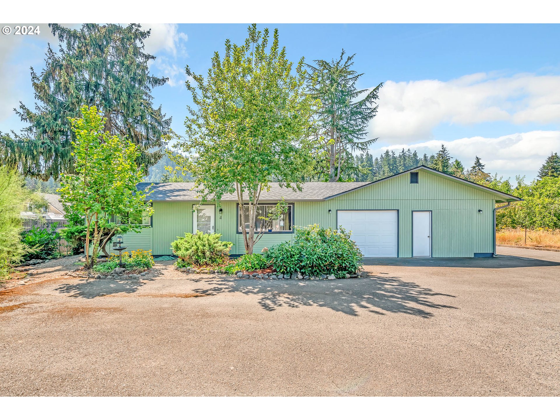 6112 Main Street Springfield, OR 97478 - Photo 47 of 47 a front view of a house with a yard and garage