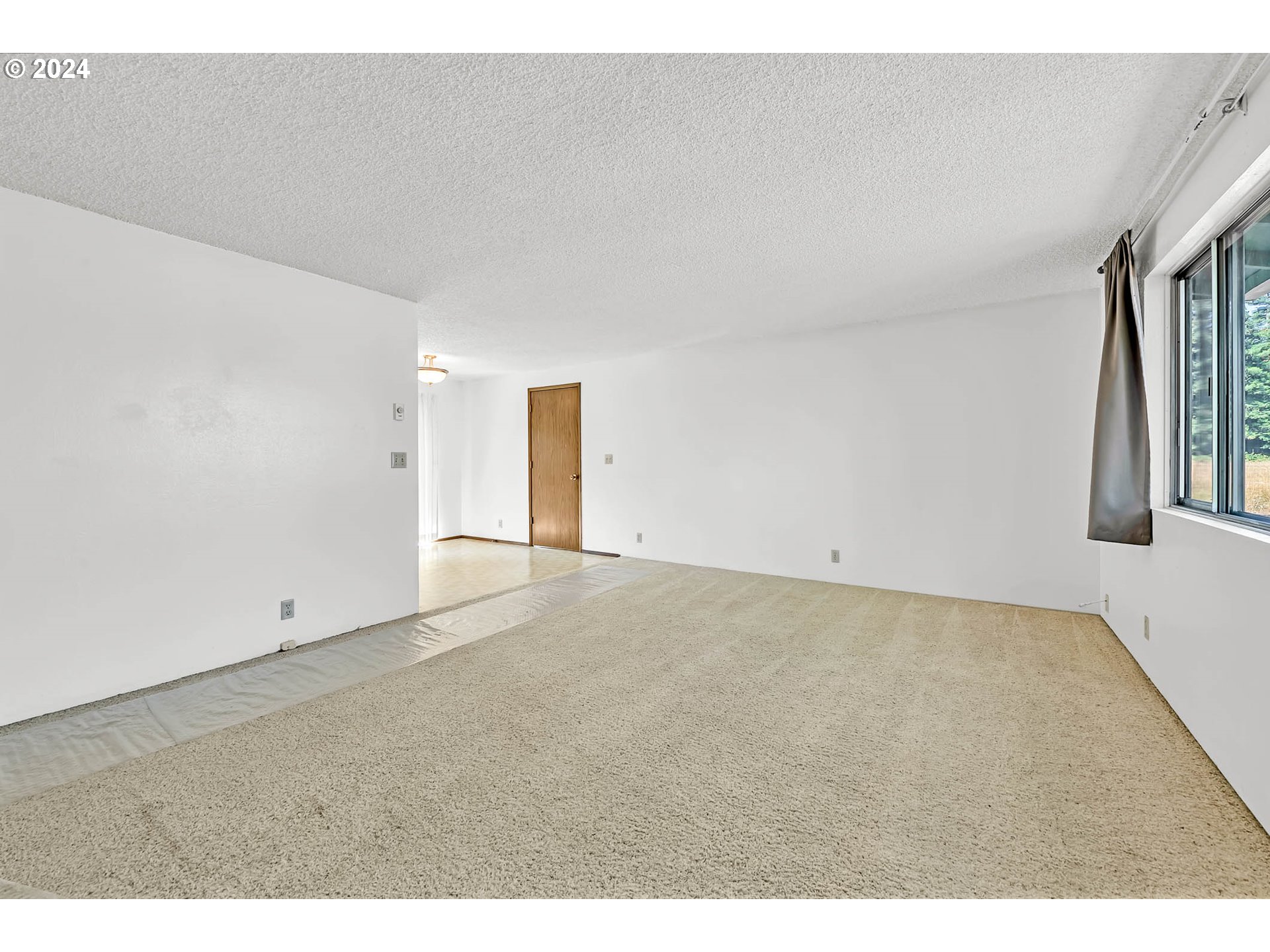 6112 Main Street Springfield, OR 97478 - Photo 5 of 47 a view of an empty room with a window