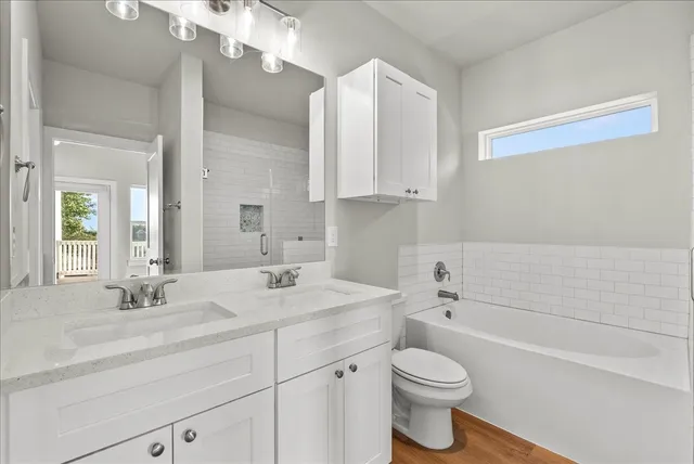 a bathroom with a sink a toilet and bathtub