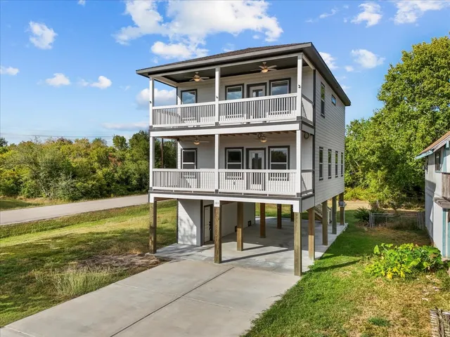 a view of a house with a yard and sitting area