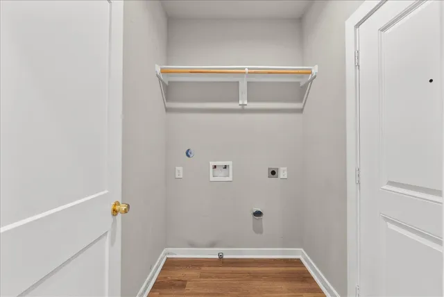 a view of storage and utility room with wooden floor