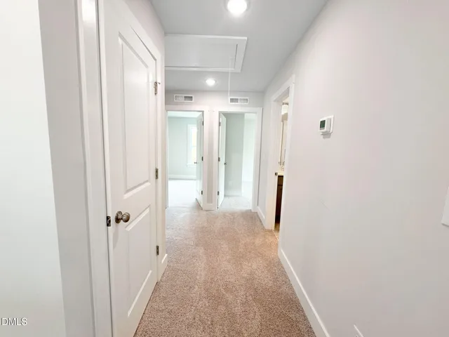 a view of a hallway with a white walls