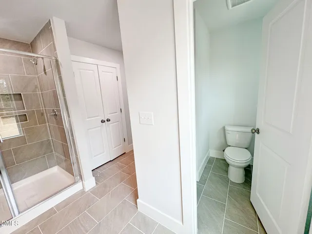a bathroom with a shower and a sink