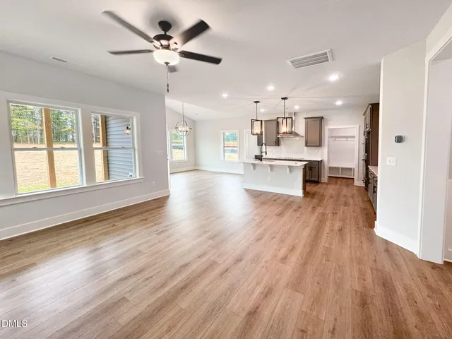 a view of kitchen with refrigerator microwave and stove