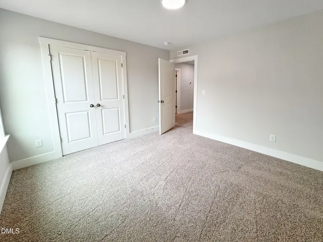 a view of an empty room and closet area