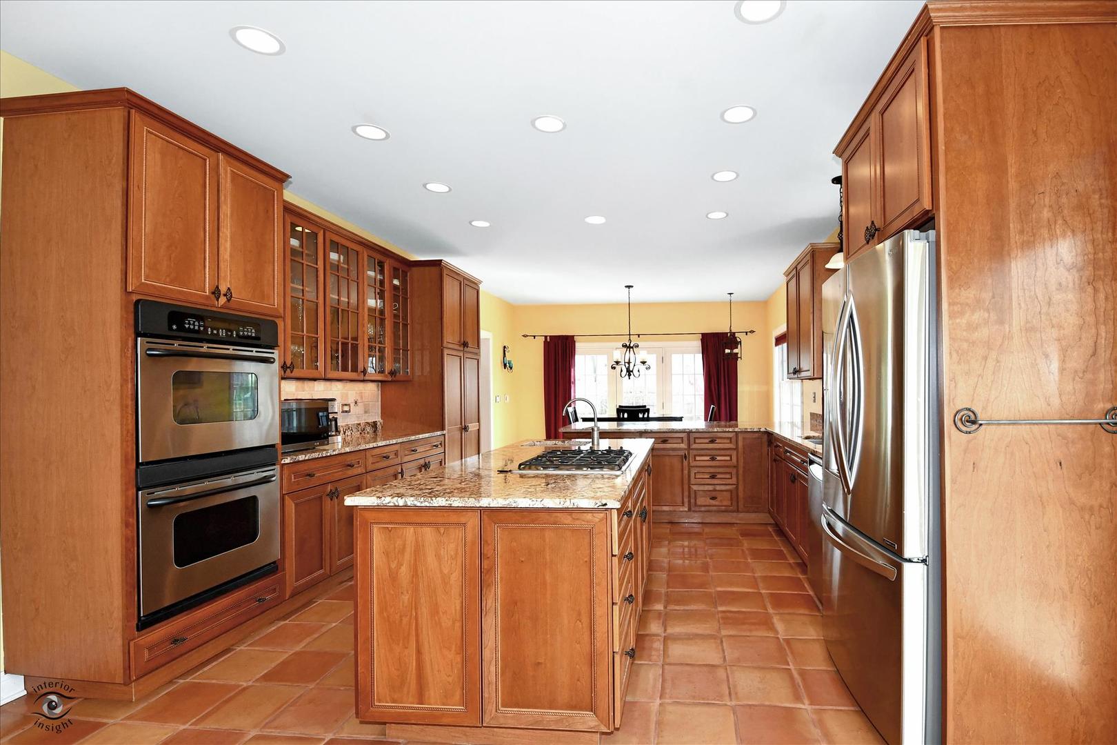 617 Hillside Road Glenview, IL 60025 - Photo 11 of 46 a kitchen with stainless steel appliances granite countertop a refrigerator a stove and a sink