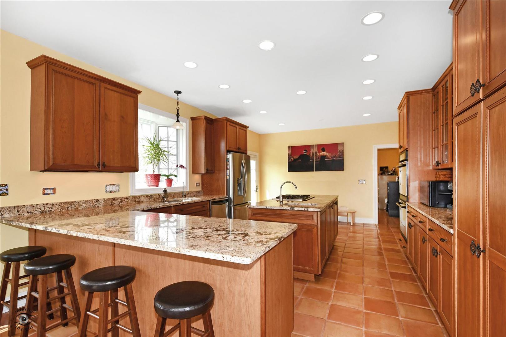 617 Hillside Road Glenview, IL 60025 - Photo 12 of 46 a kitchen with stainless steel appliances granite countertop a sink and a refrigerator