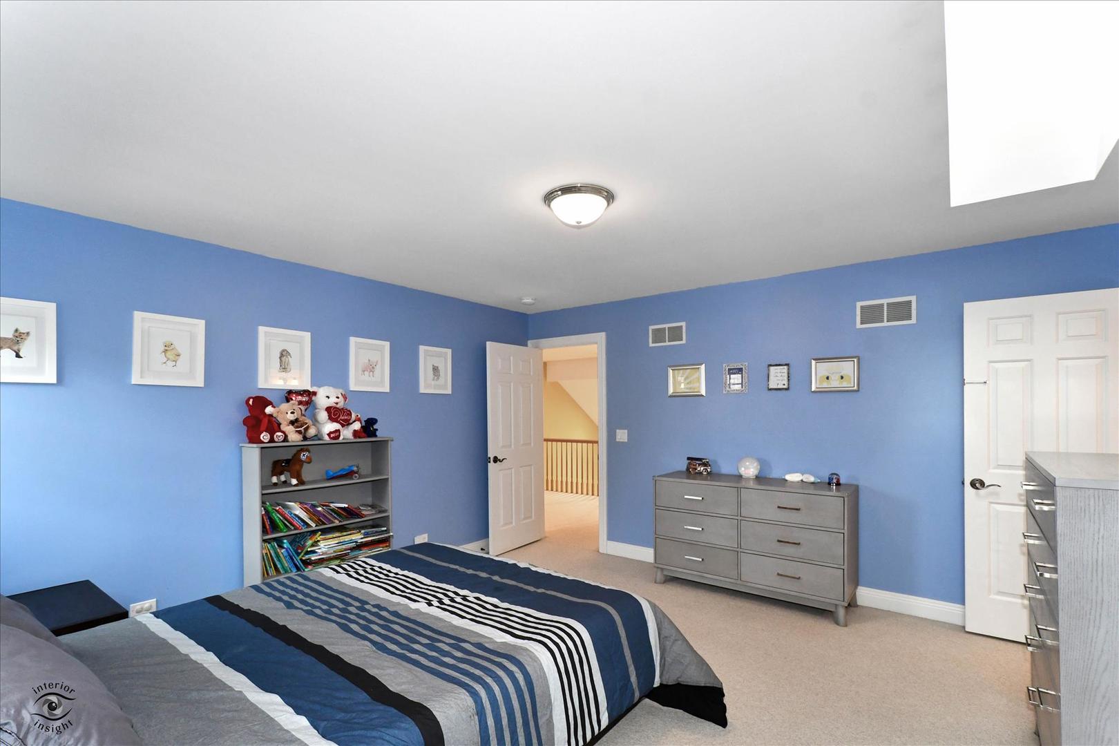 617 Hillside Road Glenview, IL 60025 - Photo 21 of 46 a bedroom with a bed and a dresser