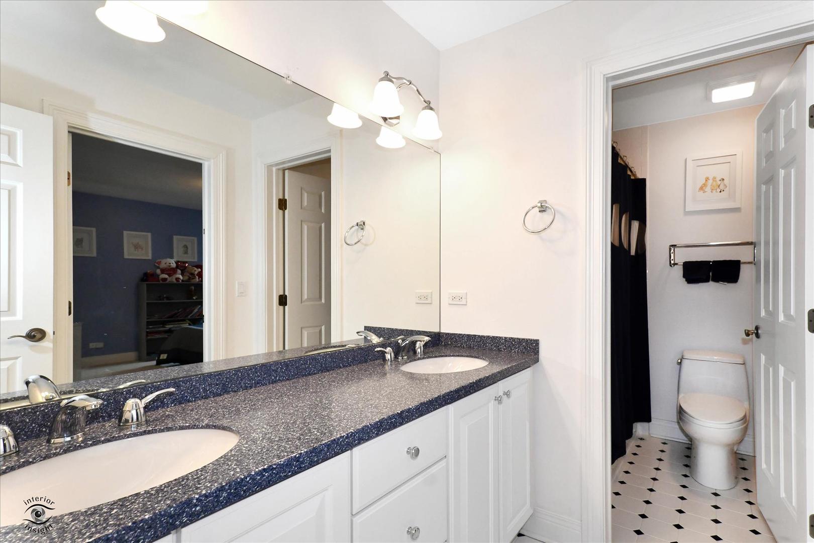 617 Hillside Road Glenview, IL 60025 - Photo 26 of 46 a bathroom with a granite countertop sink a toilet a shower and a mirror