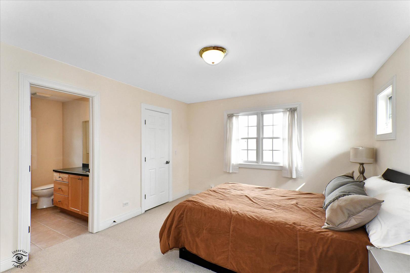 617 Hillside Road Glenview, IL 60025 - Photo 29 of 46 a bedroom with a bed and a lamp