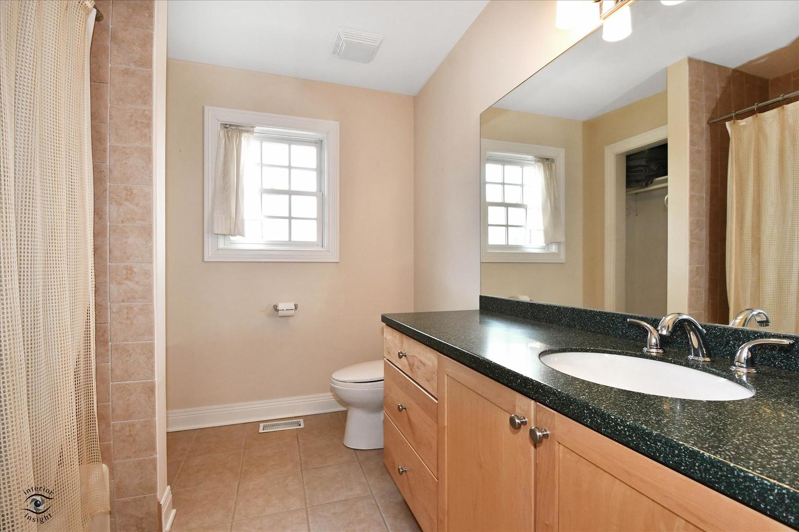 617 Hillside Road Glenview, IL 60025 - Photo 30 of 46 a bathroom with a granite countertop sink toilet and mirror