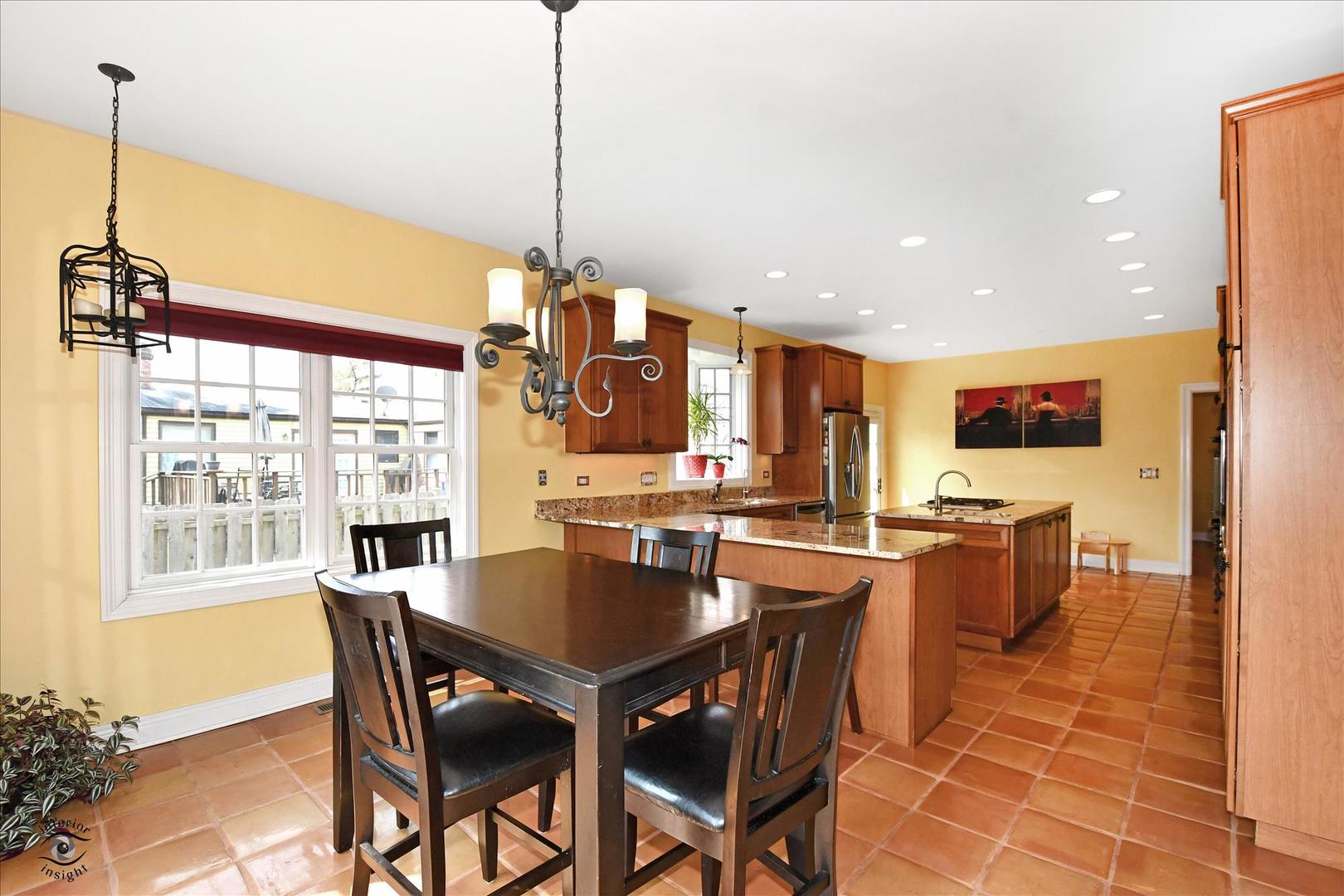 617 Hillside Road Glenview, IL 60025 - Photo 8 of 46 a view of a dining room and livingroom with furniture wooden floor a chandelier