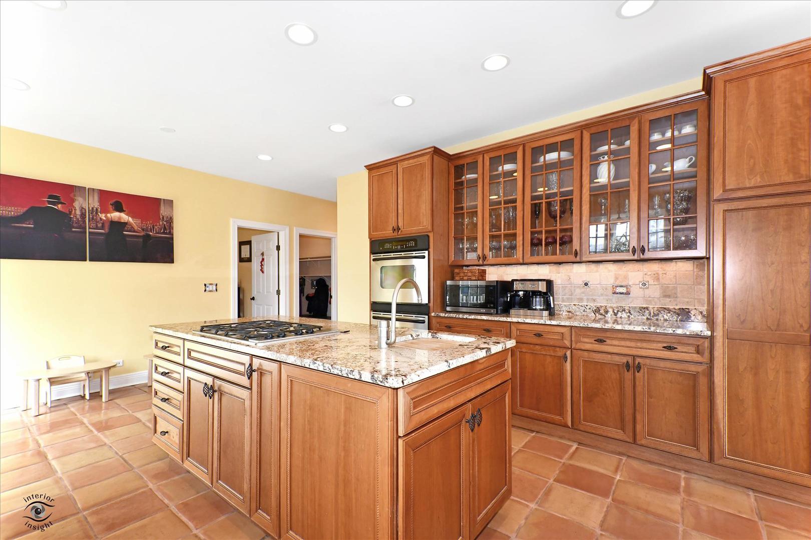 617 Hillside Road Glenview, IL 60025 - Photo 10 of 46 a kitchen with stainless steel appliances granite countertop a sink stove and refrigerator
