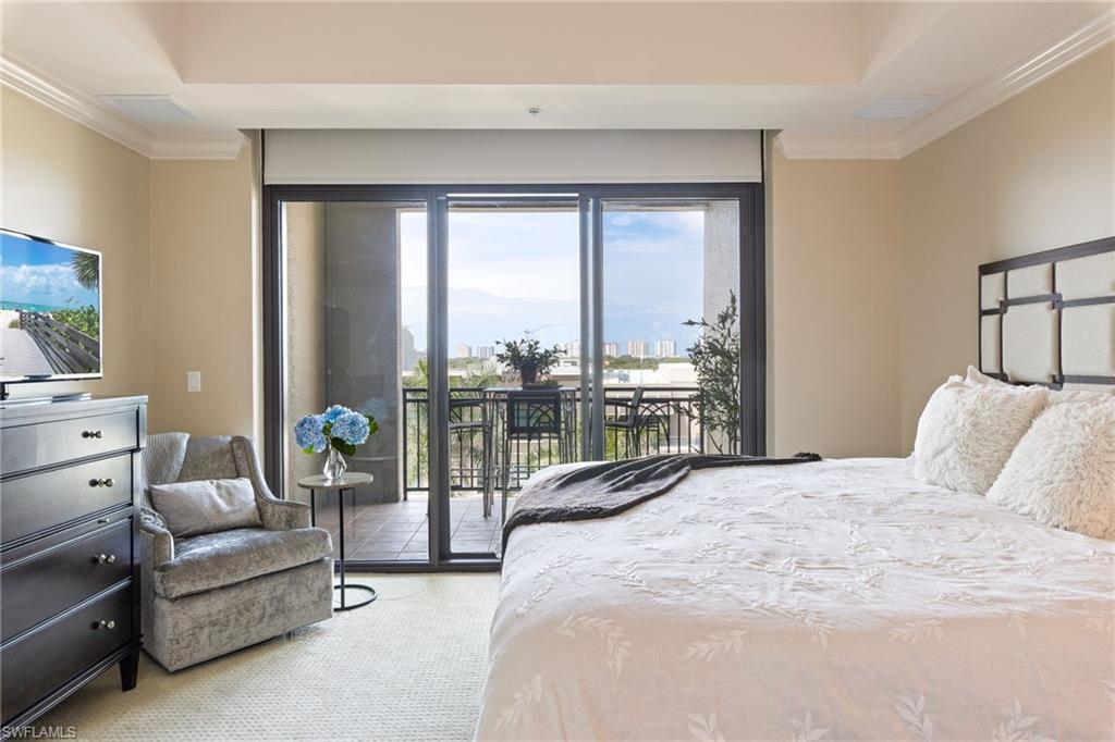 9115 Strada Place, Unit 5506 Naples, FL 34108 - Photo 11 of 46 Carpeted bedroom with ornamental molding and access to exterior