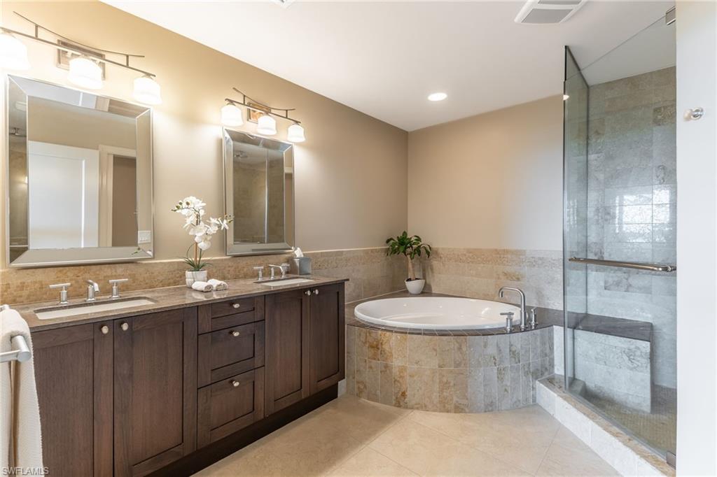 9115 Strada Place, Unit 5506 Naples, FL 34108 - Photo 12 of 46 Full bathroom with a garden tub, double vanity, tile patterned flooring, tiled shower, and recessed lighting