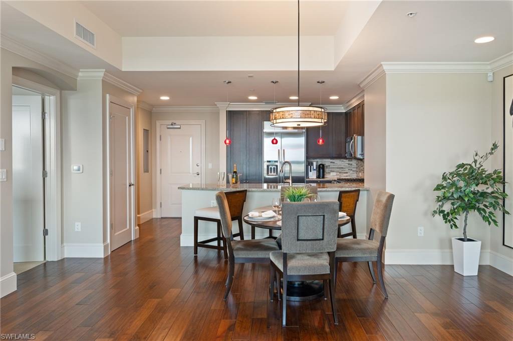 9115 Strada Place, Unit 5506 Naples, FL 34108 - Photo 19 of 46 Dining room featuring ornamental molding, dark wood-type flooring, and recessed lighting