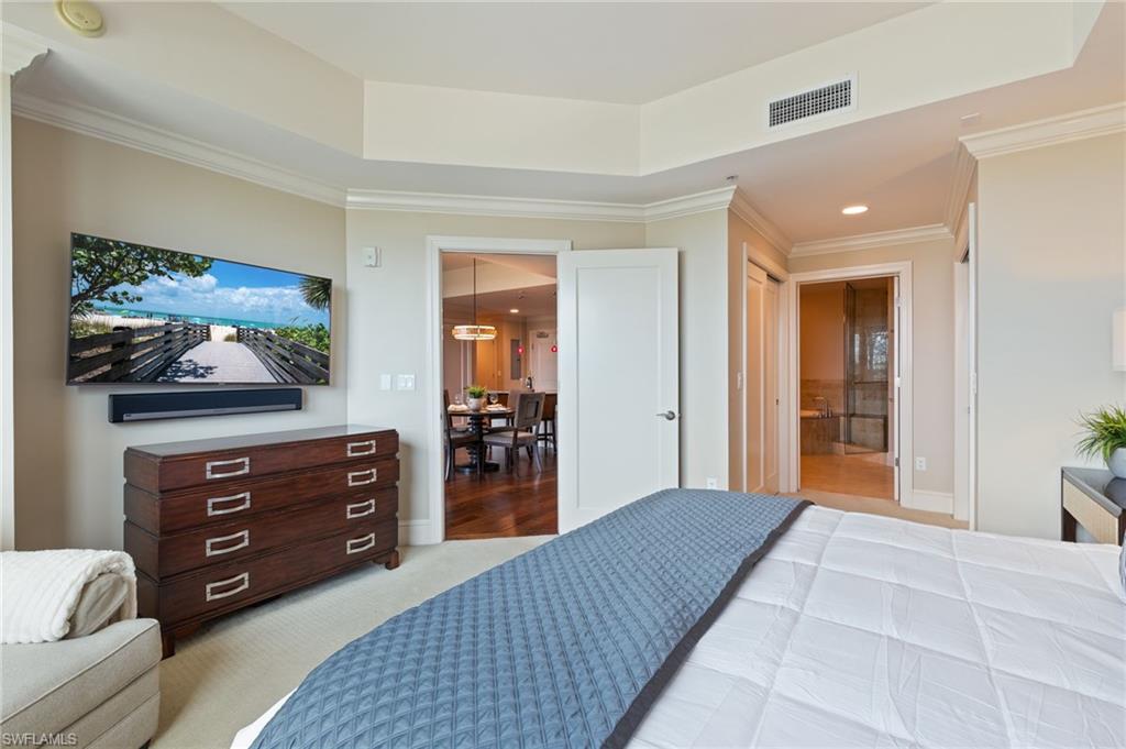 9115 Strada Place, Unit 5506 Naples, FL 34108 - Photo 24 of 46 Bedroom with crown molding, recessed lighting, ensuite bath, and light carpet