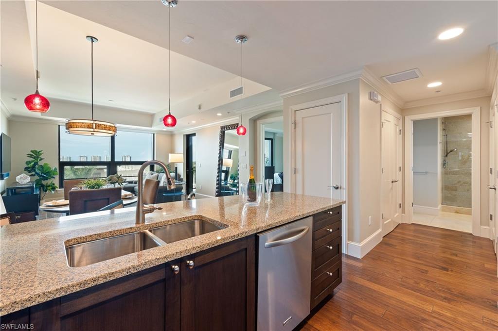 9115 Strada Place, Unit 5506 Naples, FL 34108 - Photo 46 of 46 Kitchen featuring ornamental molding, recessed lighting, stainless steel dishwasher, open floor plan, and dark brown cabinetry