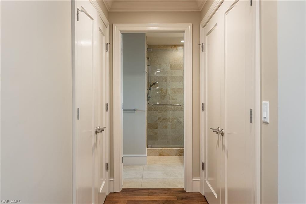 9115 Strada Place, Unit 5506 Naples, FL 34108 - Photo 27 of 46 Hallway with dark wood-style flooring ,Laundry area on the right and A/C plus water heater area to the left