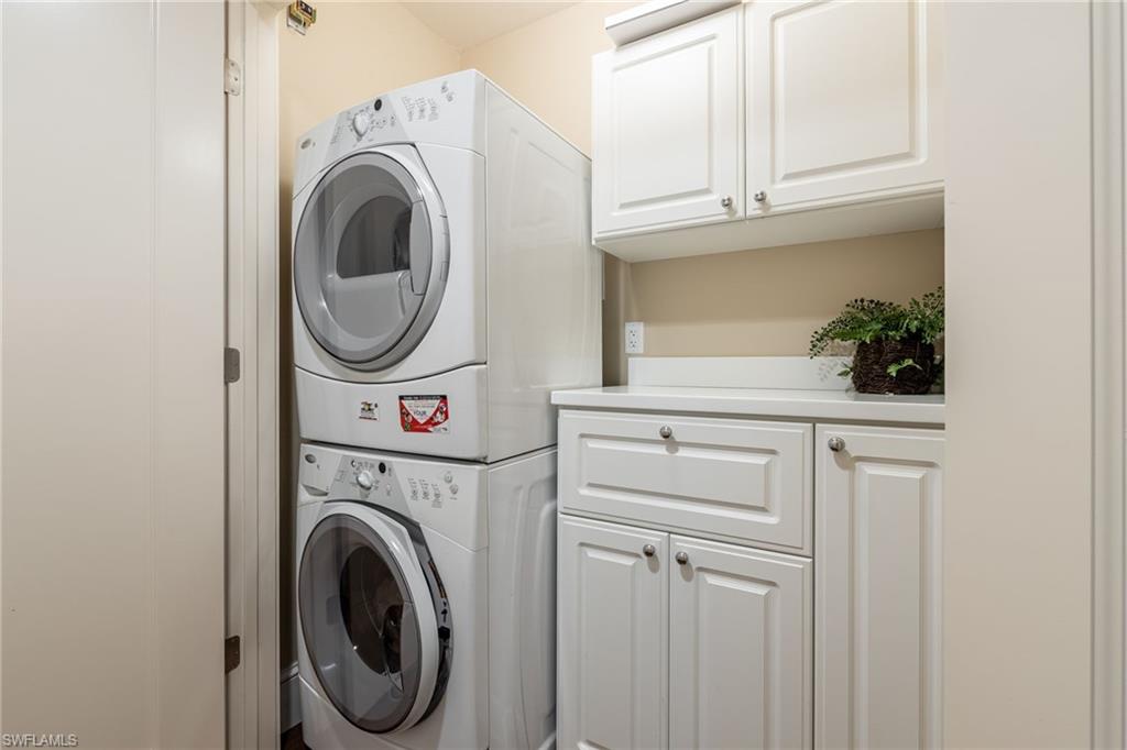 9115 Strada Place, Unit 5506 Naples, FL 34108 - Photo 28 of 46 Laundry Area featuring stacked washing machine and dryer and built-in cabinets