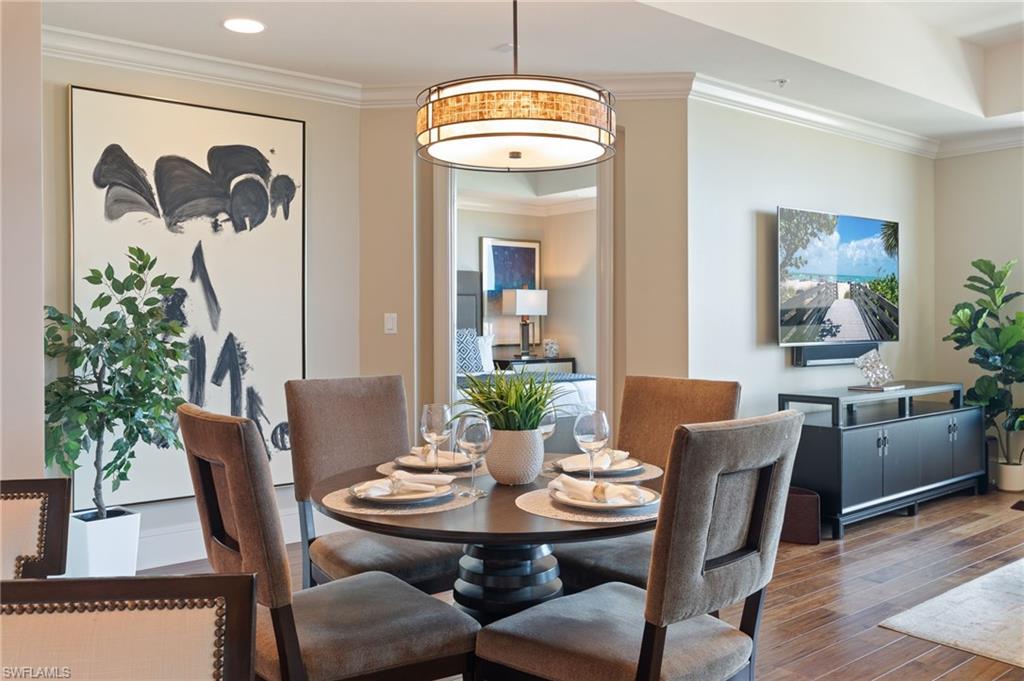 9115 Strada Place, Unit 5506 Naples, FL 34108 - Photo 5 of 46 Dining area with crown molding and wood finished floors