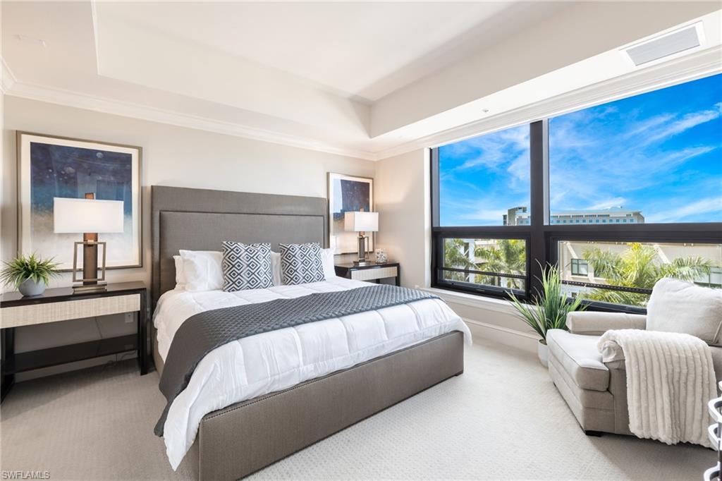 9115 Strada Place, Unit 5506 Naples, FL 34108 - Photo 7 of 46 Bedroom featuring magnificent view and crown molding, carpet flooring, and a tray ceiling